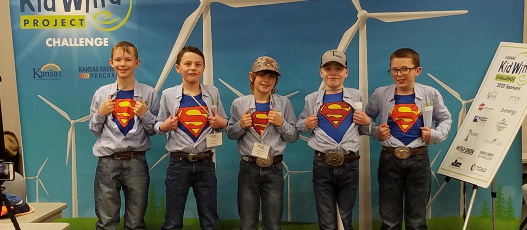 Five young boys with Superman t-shirts underneath their dress shirts.