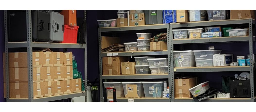 Boxes and storage containers and miscellaneous items stacked on shelves