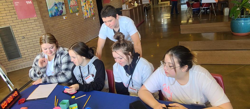 2023 Hutch KidWind - Five students at table working on knowledge quiz