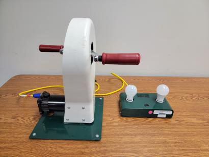 hand crank and 2 light bulbs on table