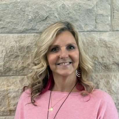 Stacy in front of limestone wall 2025