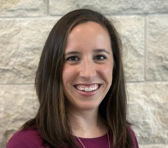 Mandy in front of the limestone wall 2025