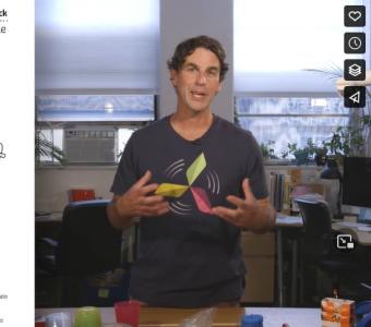 Screenshot of KidWind Video showing curriculum overview on one half of image and man speaking on other half.