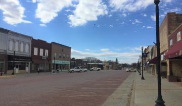 Smalltown Main Street with brick street, blue skies, and brick buildings
