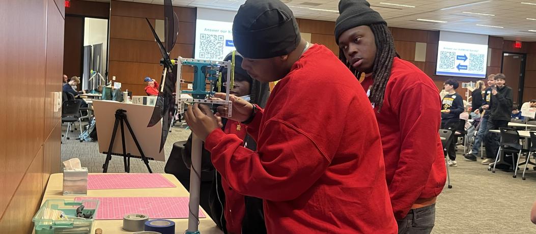 Students adjusting wind turbine